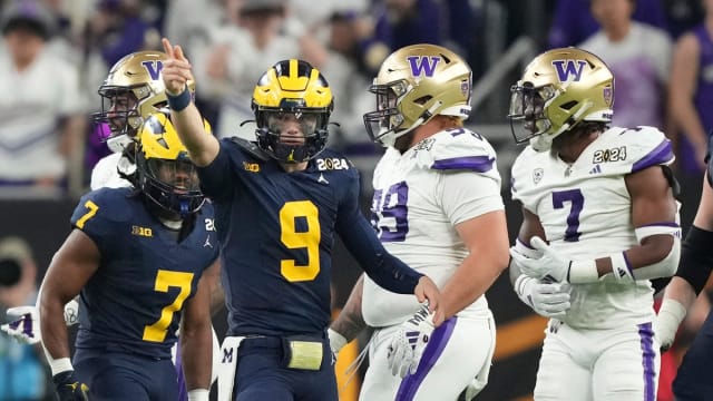 Michigan quarterback J.J. McCarthy points down the field during the second half of the College Football Playoff national championship game against Washington at NRG Stadium in Houston, Texas on Monday, Jan. 8, 2024.